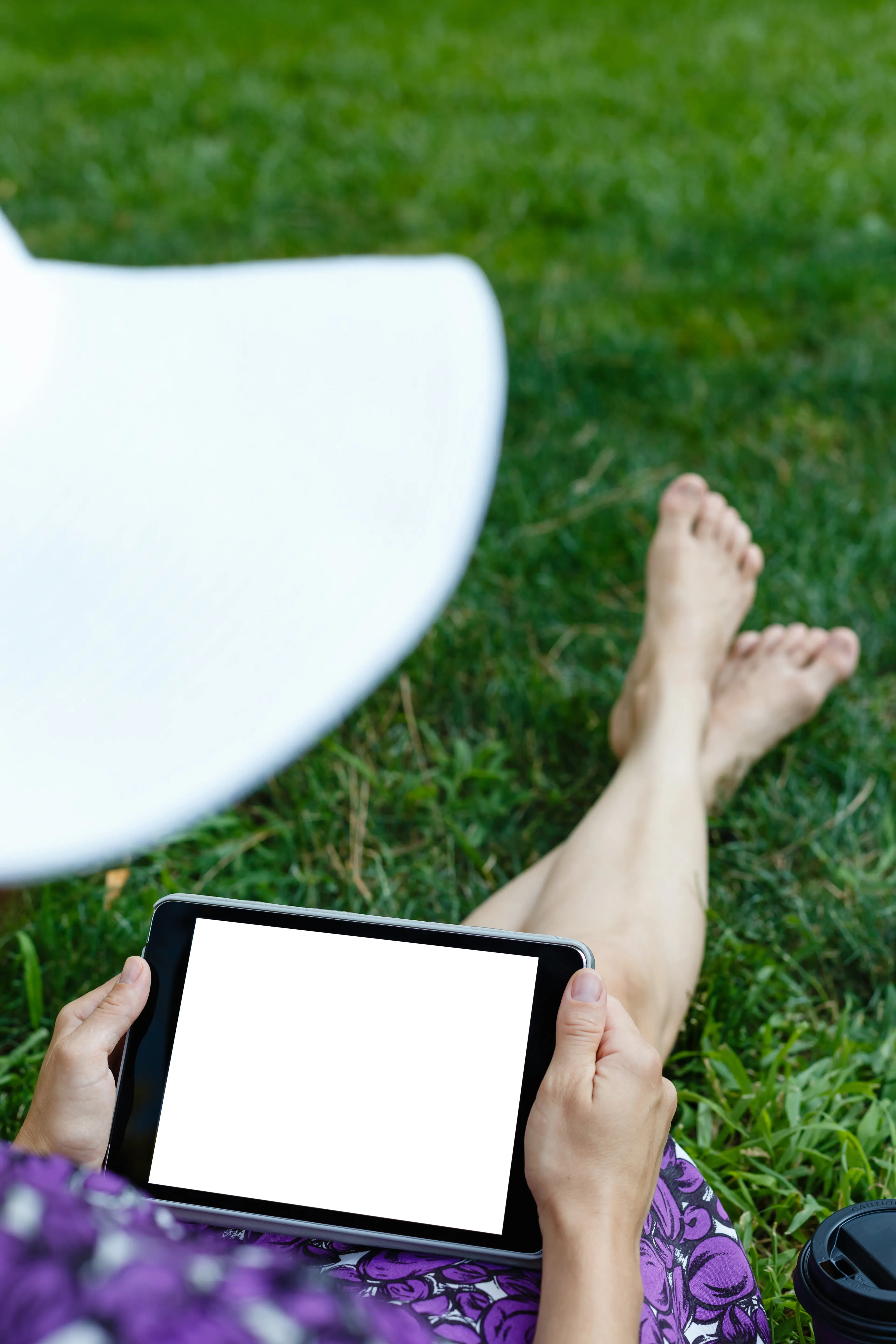 A woman on the grass with a tablet